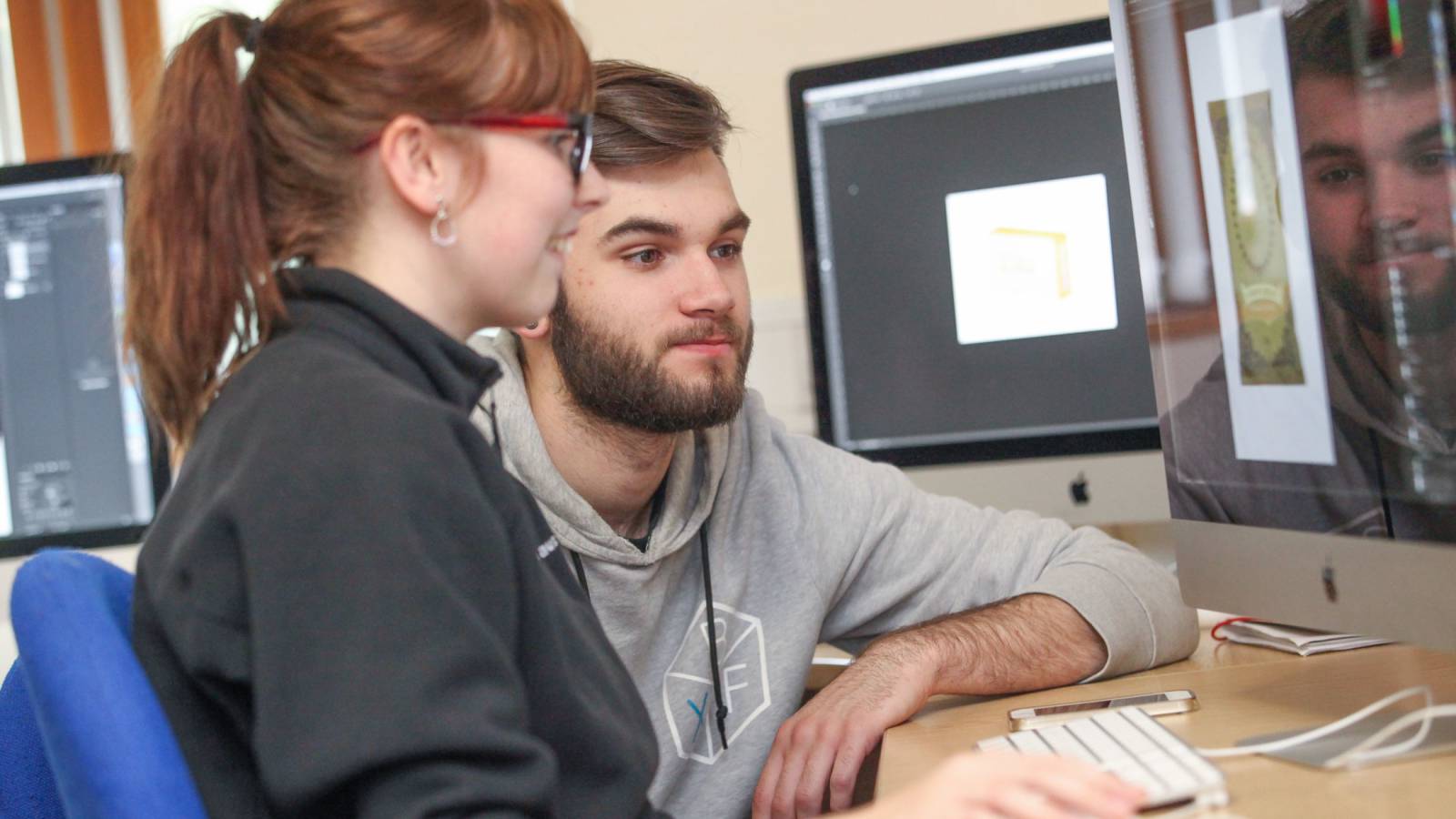 Female and Male learner working on an Apple iMac