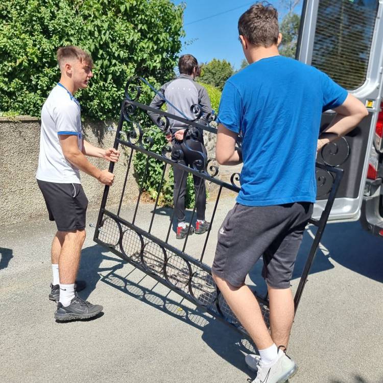 Students taking the gate to Elfyn Williams’ house in Harlech