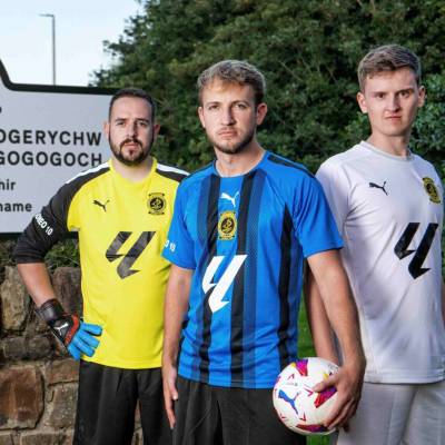 Llanfairpwll players with the sign presented to the village featuring the La Liga logo