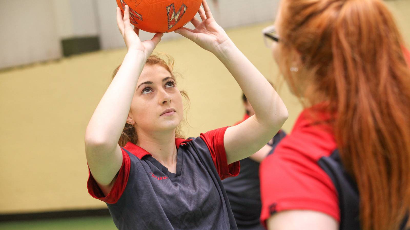 Learners playing netball in the sports centre