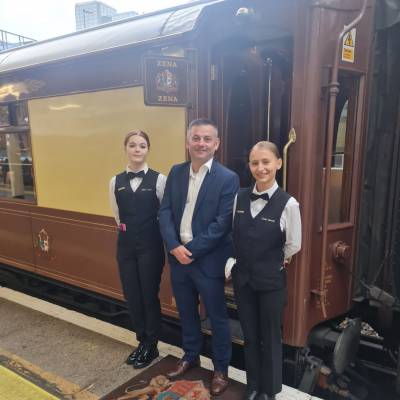 Rhian James a Yuliia Batrak gyda'r darlithydd Glenydd Hughes o flaen trên British Pullman