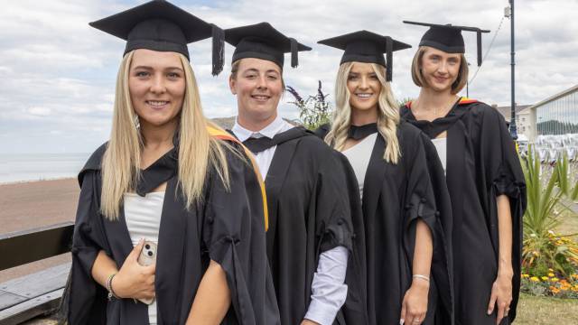 Graduates celebrating on the Promenade in Llandudno