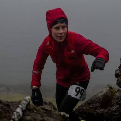 Alwen Williams reaching the top of a climb in Ras y Moelwyn