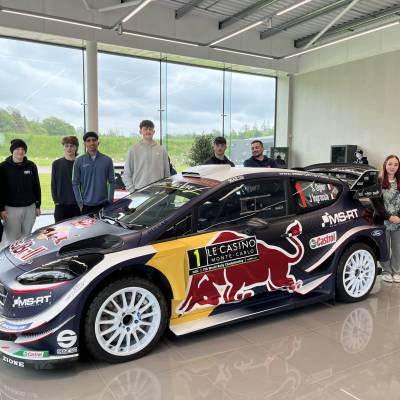 Coleg Menai students with a Ford World Rally car at the M-Sport factory in Cumbria