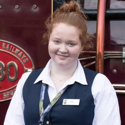 Coleg Menai student Efa India Everitt-Mcall outside a Ffestiniog and Welsh Highland Railway train