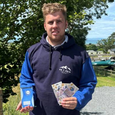 Euron Jones with his trophy and cash prize after winning Grŵp Llandrillo Menai’s Entrepreneur of the Year Award