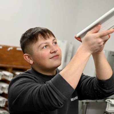 Rehau employee and former Coleg Meirion-Dwyfor student Owain Cunnington inspecting a part