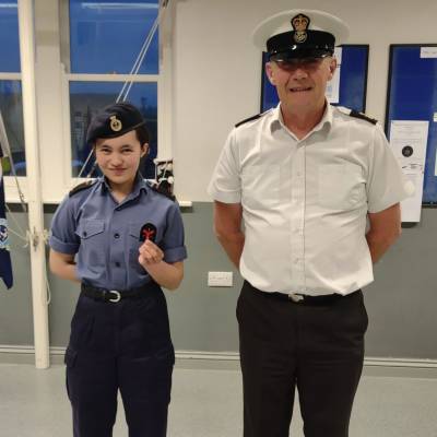 Coleg Menai student Katie Jones with a Sea Cadets officer after being presented with her 1st class badge in marine engineering