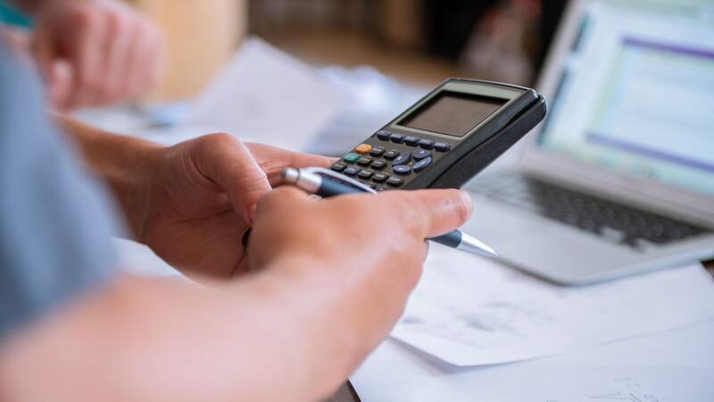 A man using a calculator