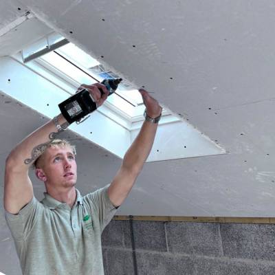 Harry Sutherland working on a wall