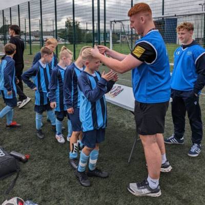 Children from Ysgol Craig y Don receiving their medals after winning the Urdd Conwy open primary school football tournament