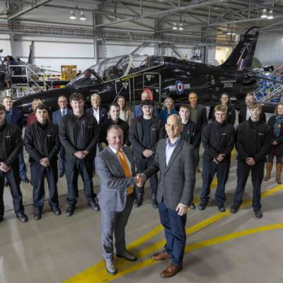 Staff from Babcock and Grŵp Llandrillo Menai photographed with a Hawk Aircraft