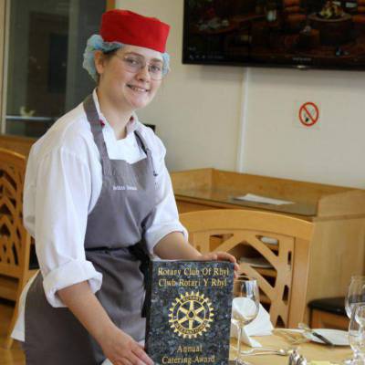 Coleg Llandrillo student Bethan Edwards with The Rotary Club of Rhyl Catering Award in the Orme View Restaurant at the Rhos-on-Sea campus