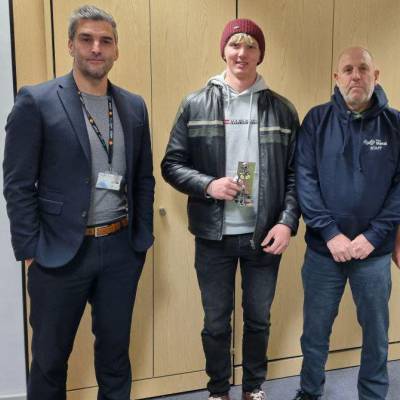 Harry Sutherland holding his trophy after winning the SkillBuild2024 plastering competition, with Mark Allen, Steven Ellis and Wayne Taylor