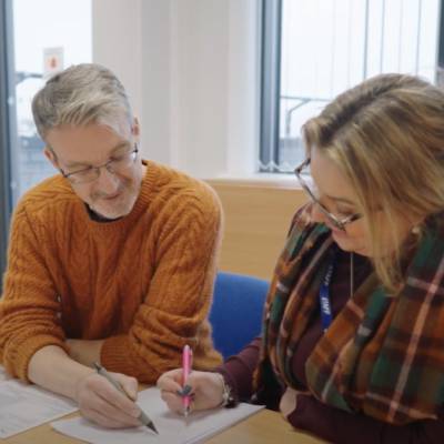 Multiply tutor Anthony Harrison helping a learner with her work