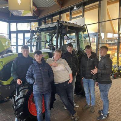 Coleg Glynllifon students in front of a 780 Lexion combine harvester at the Claas agricultural machinery factory in Germany