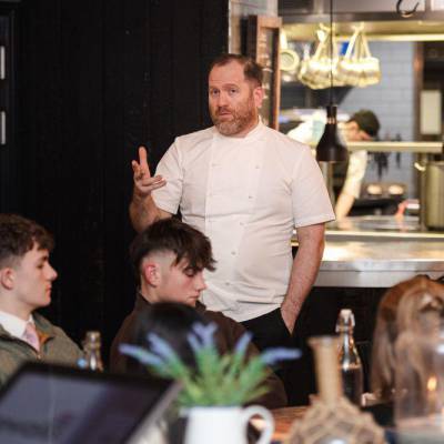 Bryn Williams talking to school students and teachers at his Porth Eirias restaurant