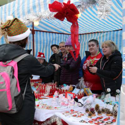 Skills for Life and Work students behind a stall at the annual Christmas market at Coleg Llandrillo’s Rhos-on-Sea campus