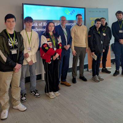 Ian Derrick and lecturer Guto Wyn Jones with students who organised the annual enterprise conference at Coleg Menai