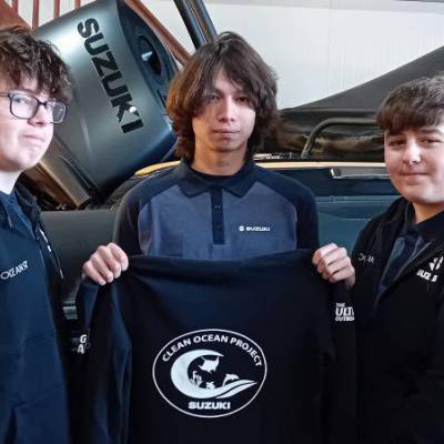 Coleg Meirion-Dwyfor students Tom, Ben and Osian showing the hoodies provided by their sponsor Suzuki Marine and Harbour Marine Services