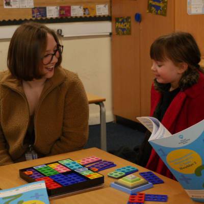 Children using numicon packs and other numeracy tools with a Multiply staff member at Ysgol Twm o'r Nant