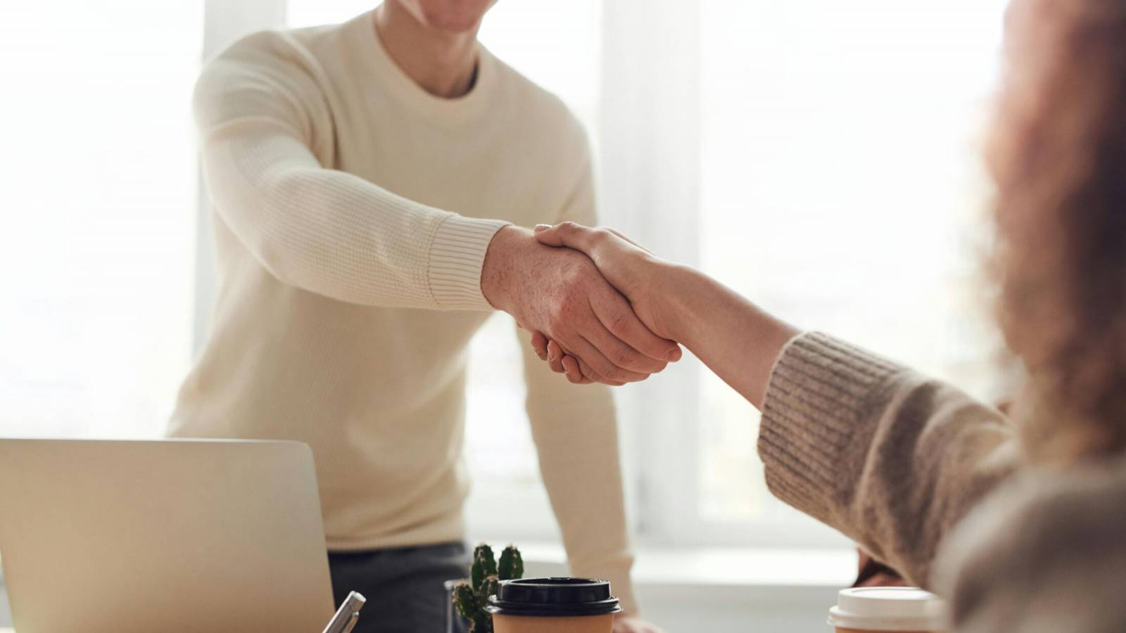 Learner and staff member shaking hands