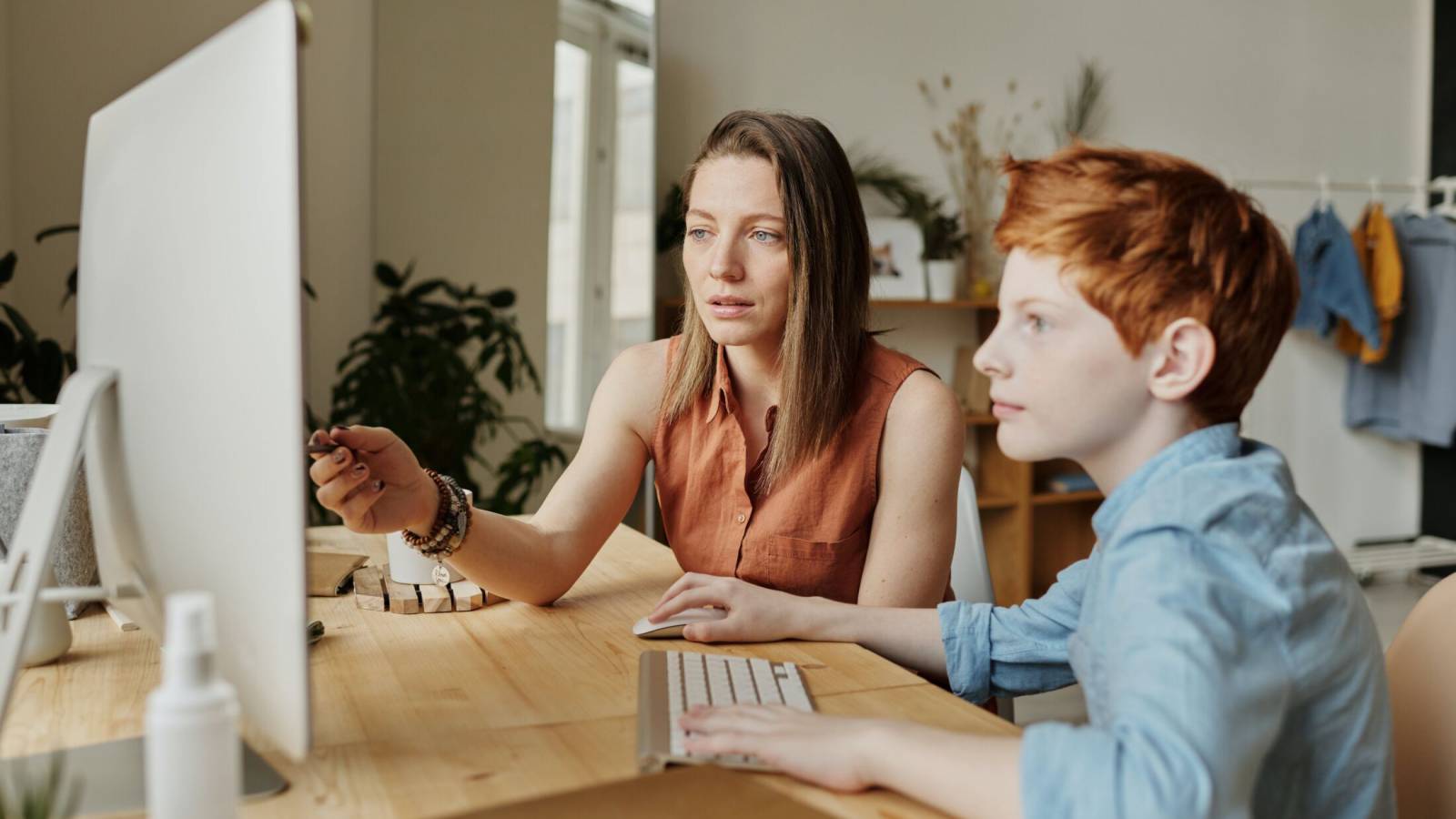 Parent working on computer with child