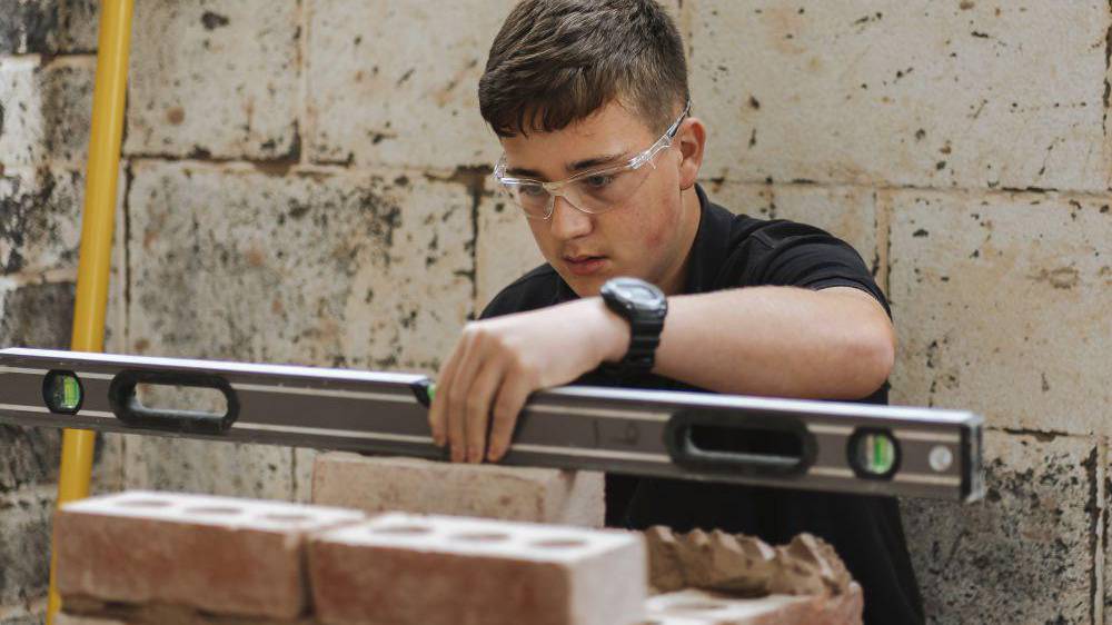 Student building a wall