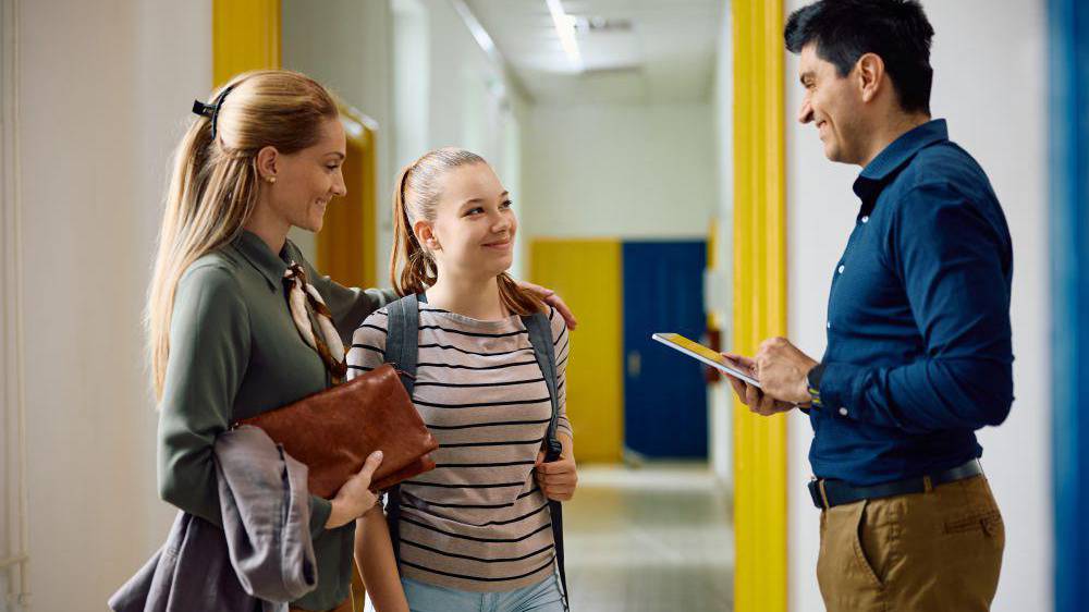 Parent and student with teacher