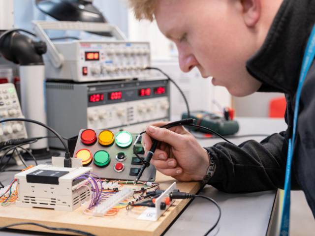 Student working on an electrical board