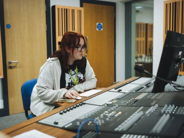 Student using music equipment