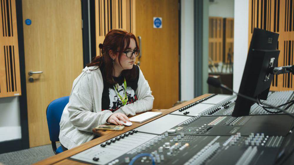 Student using music equipment